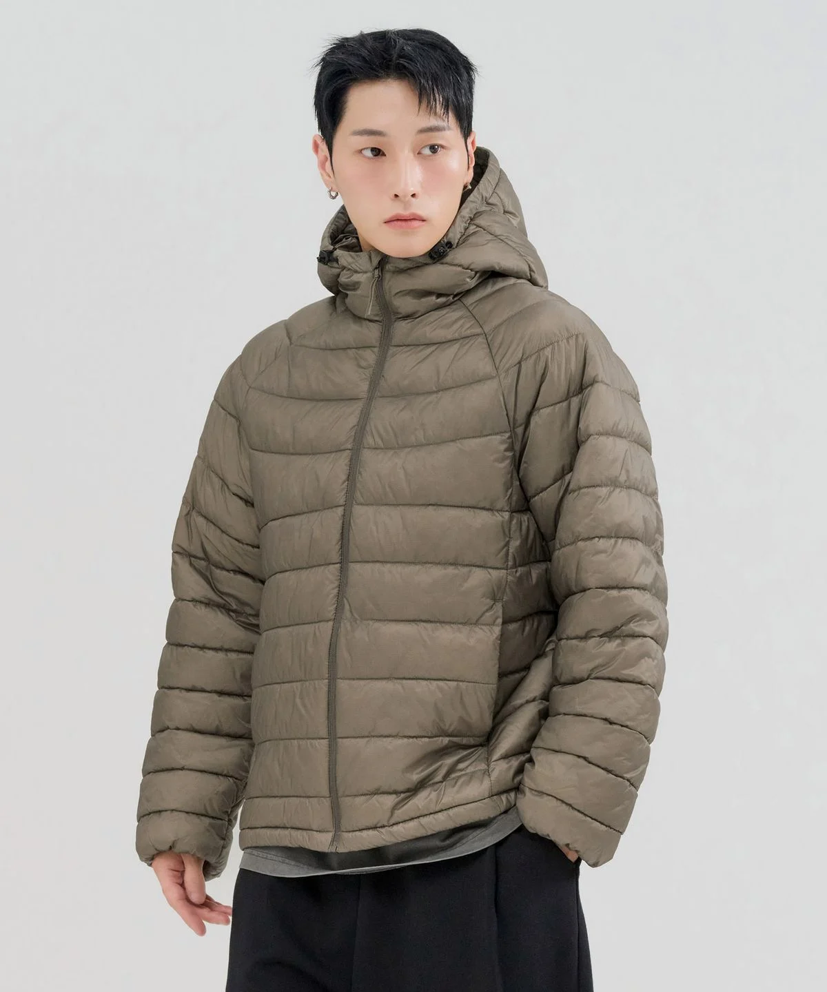 178cm 남성이 그레이색 맨투맨 위에 체이스컬트 패딩을 걸치고 가볍게 산책하는 전신 샷